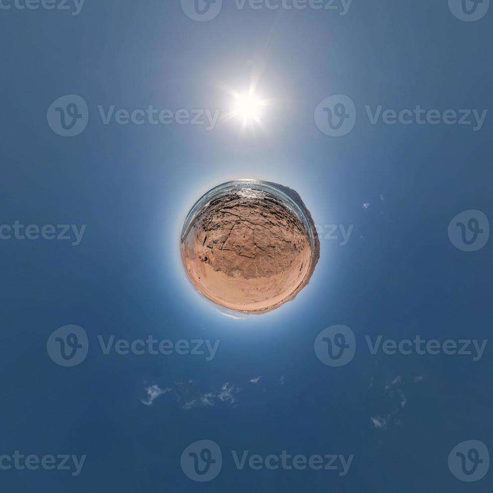 yellow sand tiny planet in blue sky with beautiful clouds. Transformation of spherical panorama 360 degrees. Spherical abstract aerial view. Curvature of space. photo