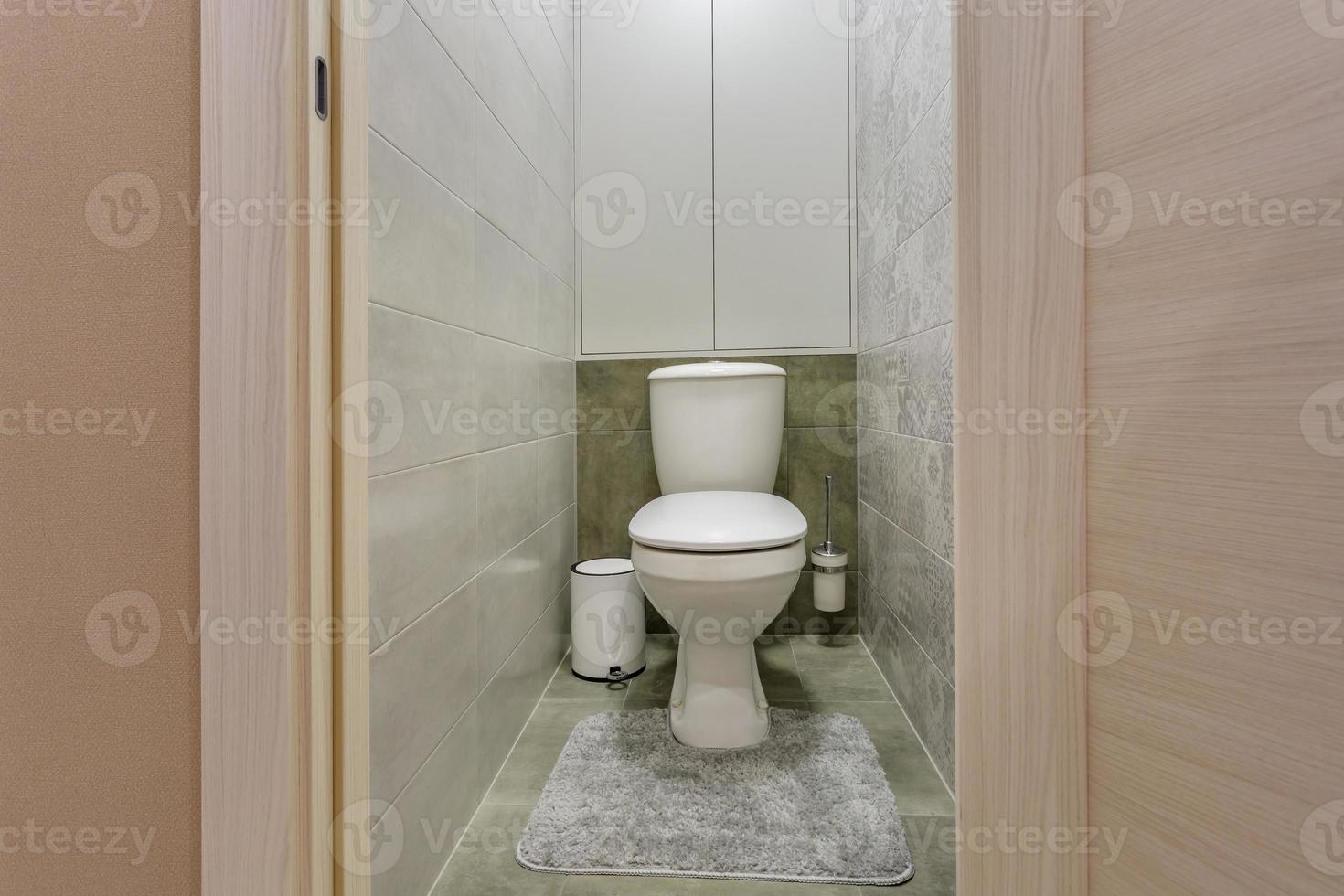 white ceramic toilet bowl in restroom photo