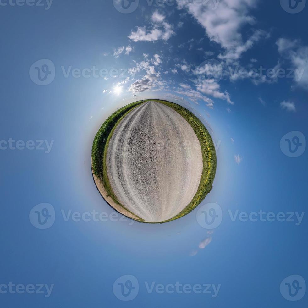 tiny planet in blue sky with beautiful clouds. Transformation of spherical panorama 360 degrees. Spherical abstract aerial view. Curvature of space. photo