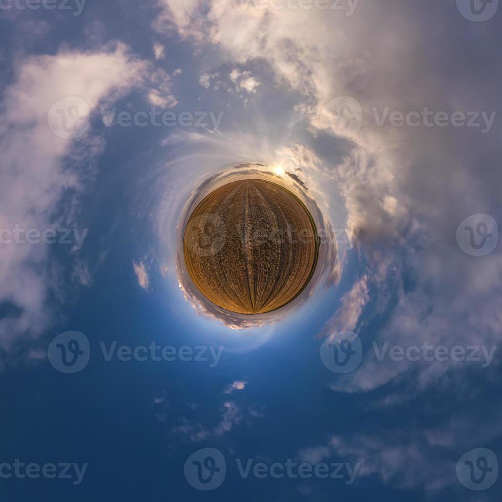 tiny planet in blue sky with beautiful clouds. Transformation of spherical panorama 360 degrees. Spherical abstract aerial view. Curvature of space. photo