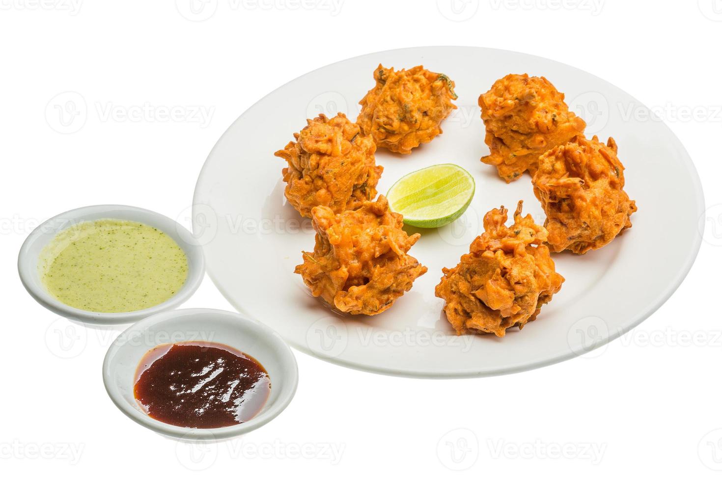 Onion bhajee on the plate and white background photo