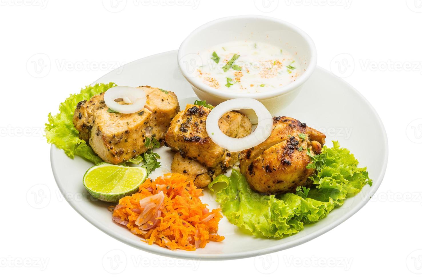 Chicken Tikka on the plate and white background photo