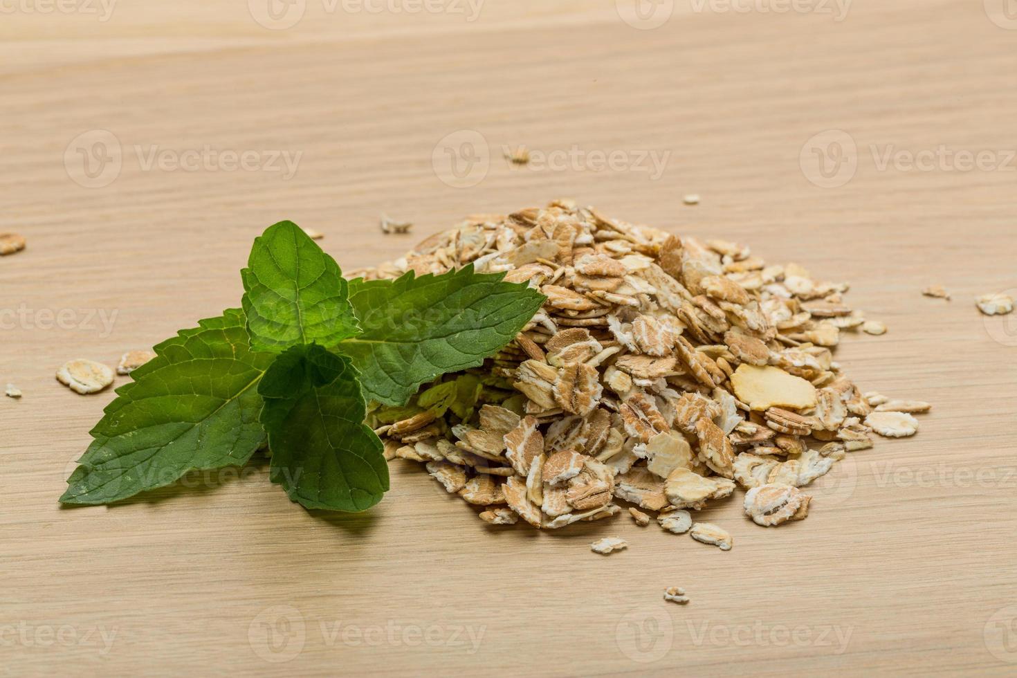 Oats on wooden background photo