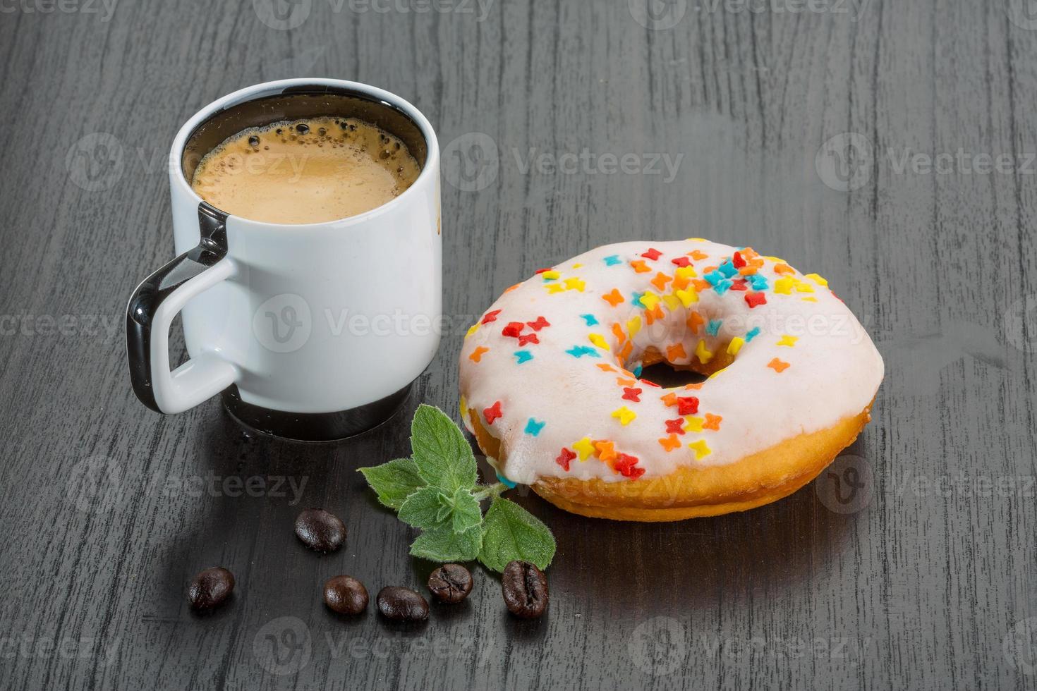 Coffee with donuts on wooden background photo