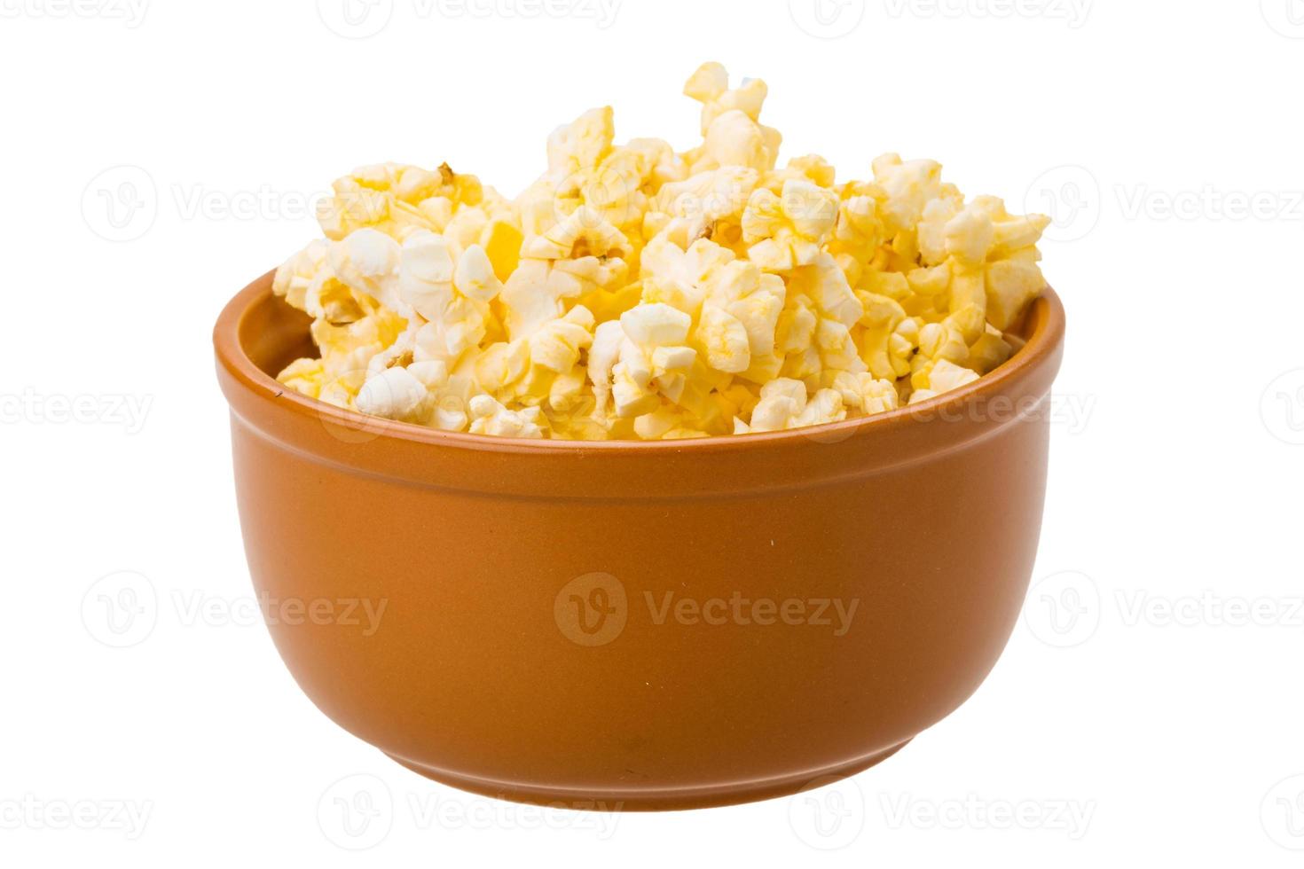 Popcorn in a bowl isolated on white photo