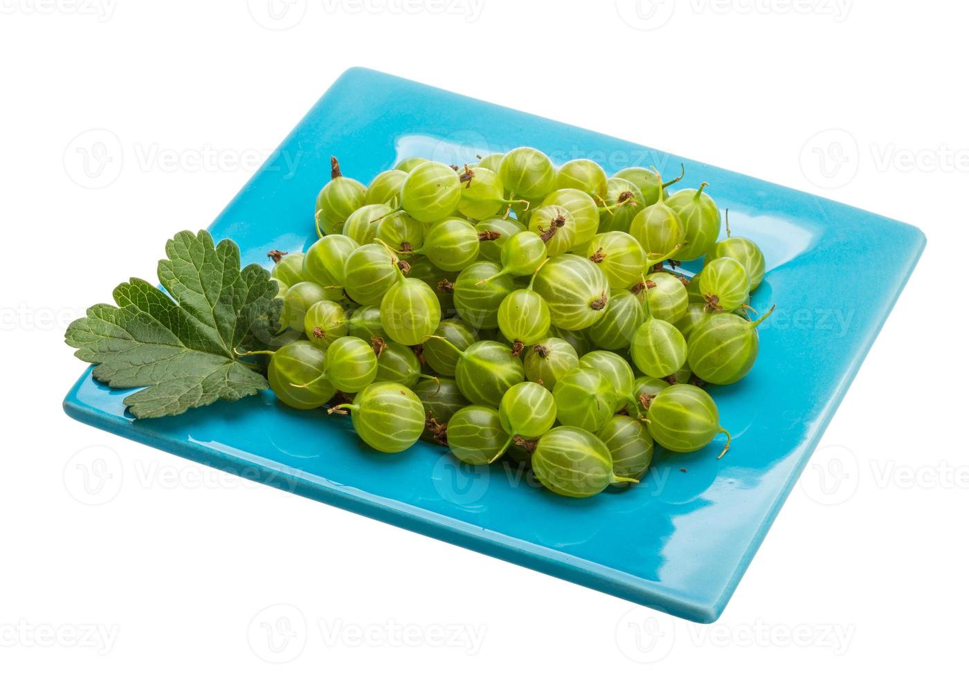 Gooseberries on the plate and white background photo