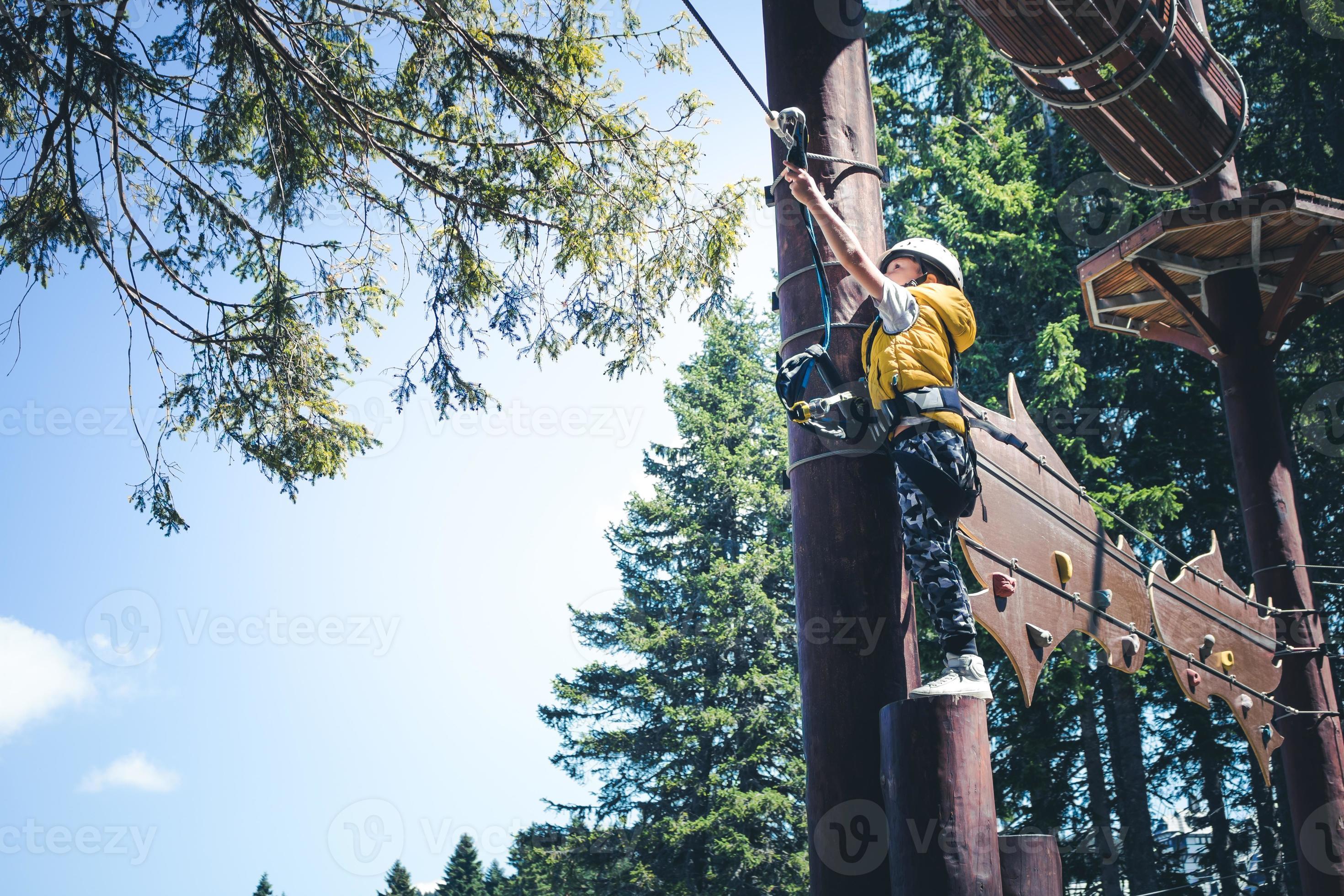 Small boy getting ready for rappelling at zip line in nature. 10908483