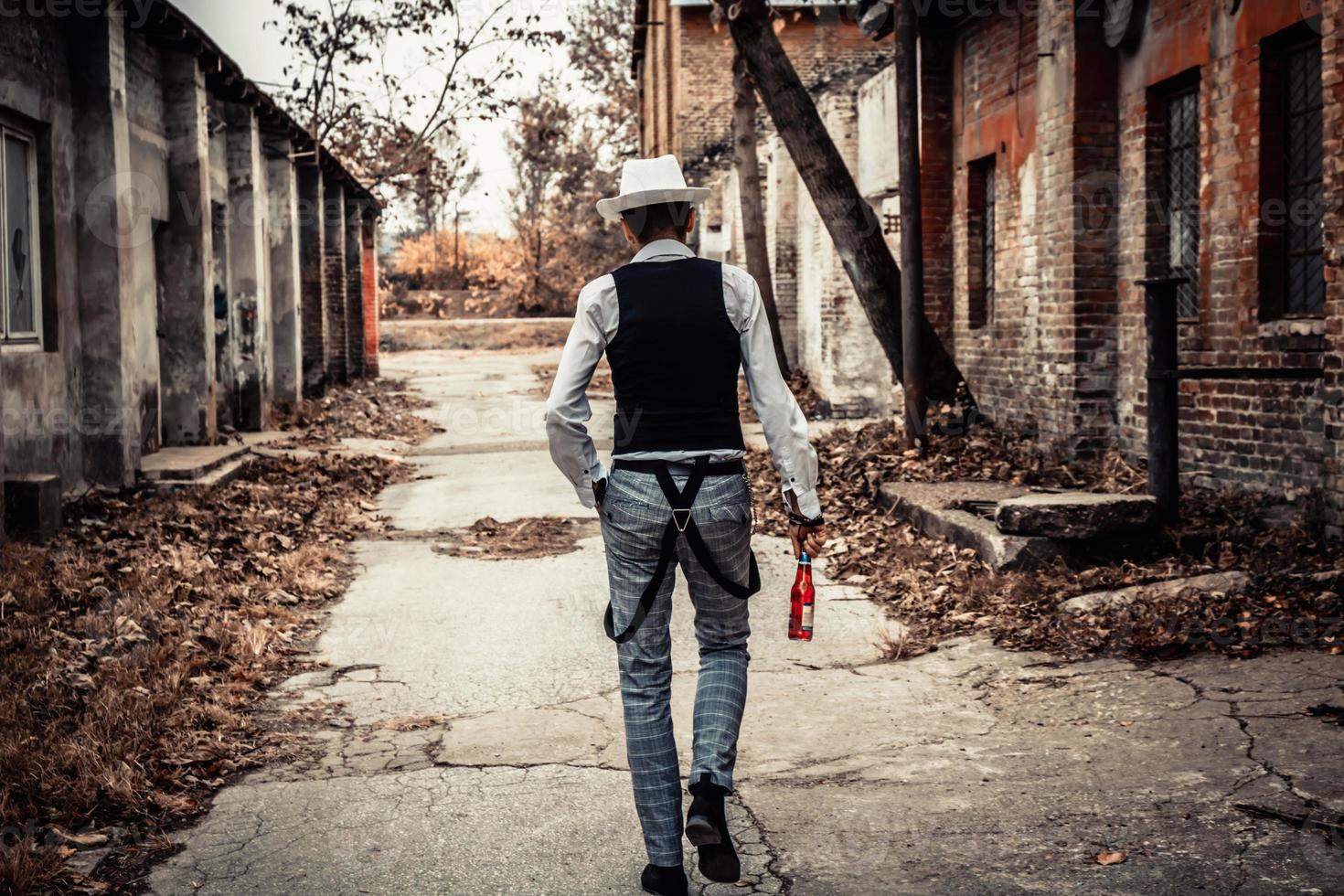 Rear view of retro-styled man walking on the street. photo