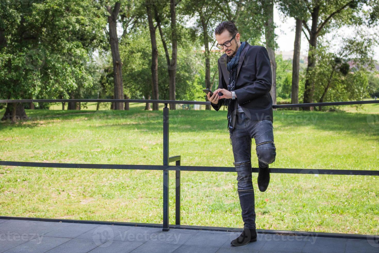 Businessman using mobile phone on a terrace. photo