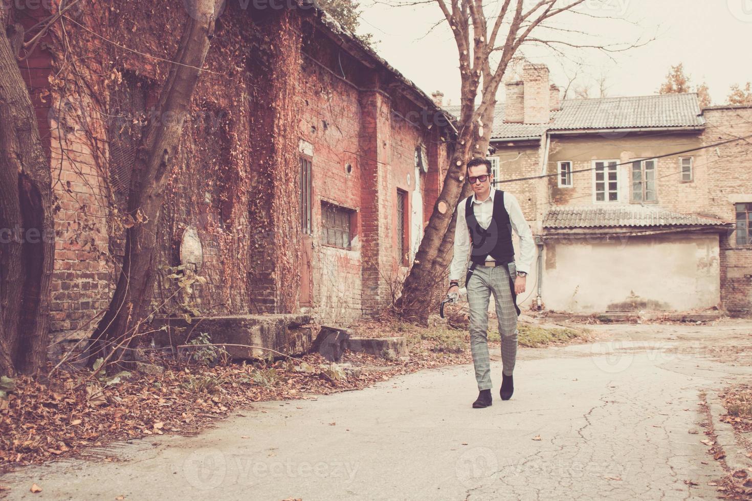 Full length of a man walking through the town. photo