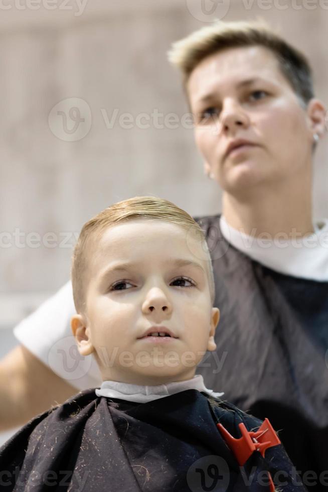 Below view of boy at hairdresser's. photo