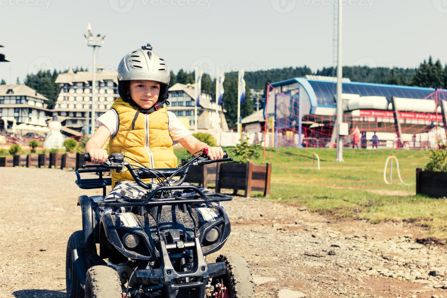 Small boy on a quadbike in nature. photo