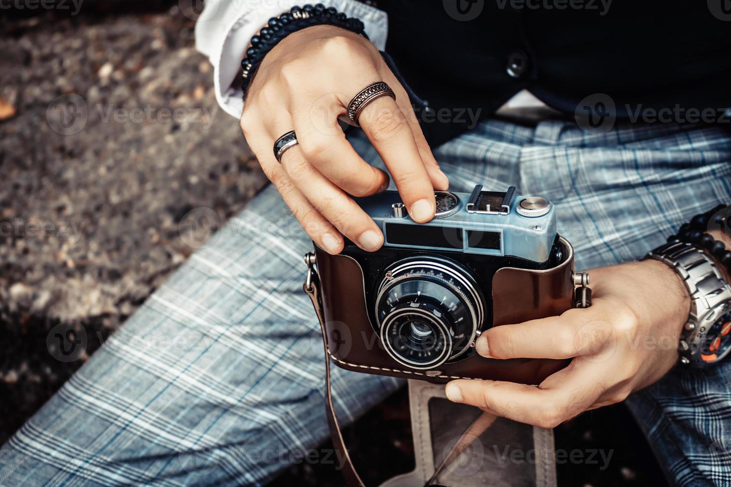 Close-up of man using analog photo camera.