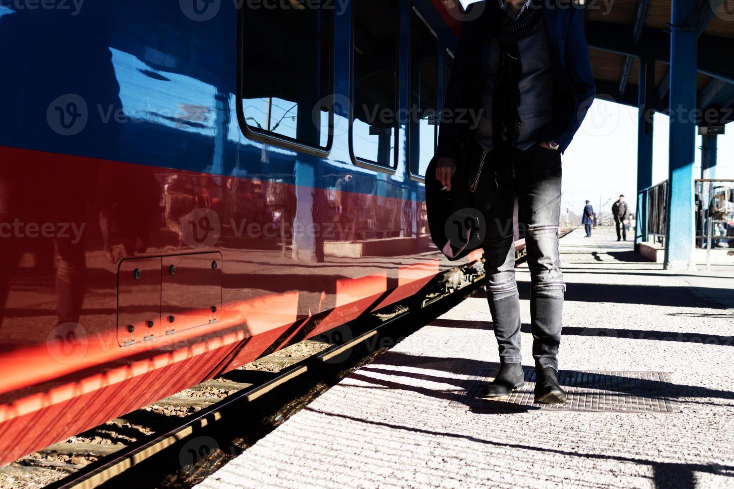 Unrecognizable man walking at train station. photo