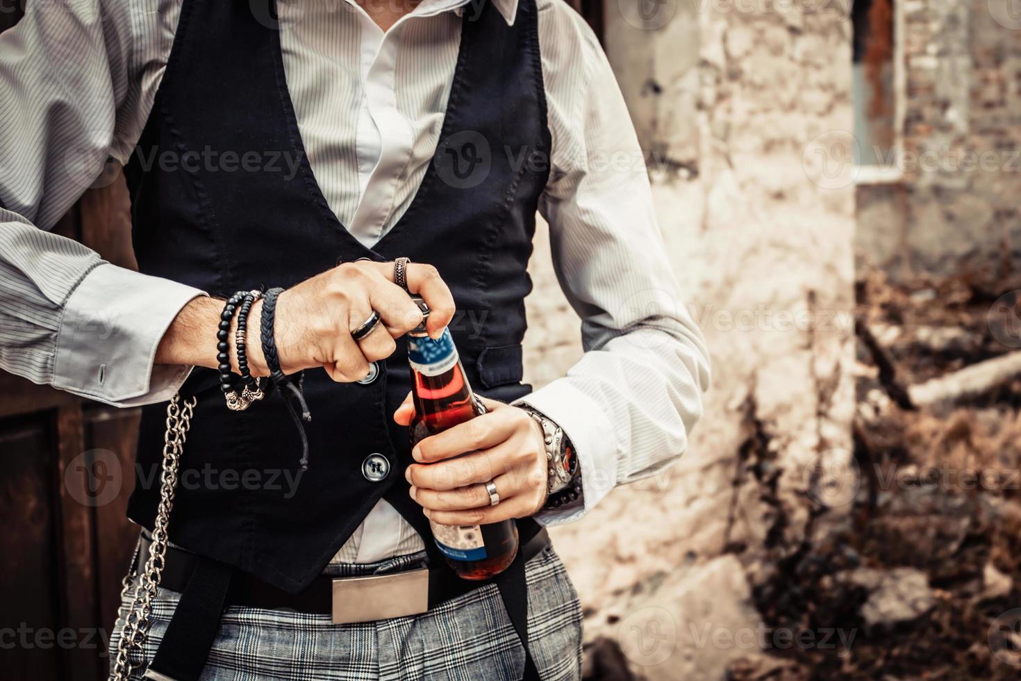 Unrecognizable man opening beer bottle. photo
