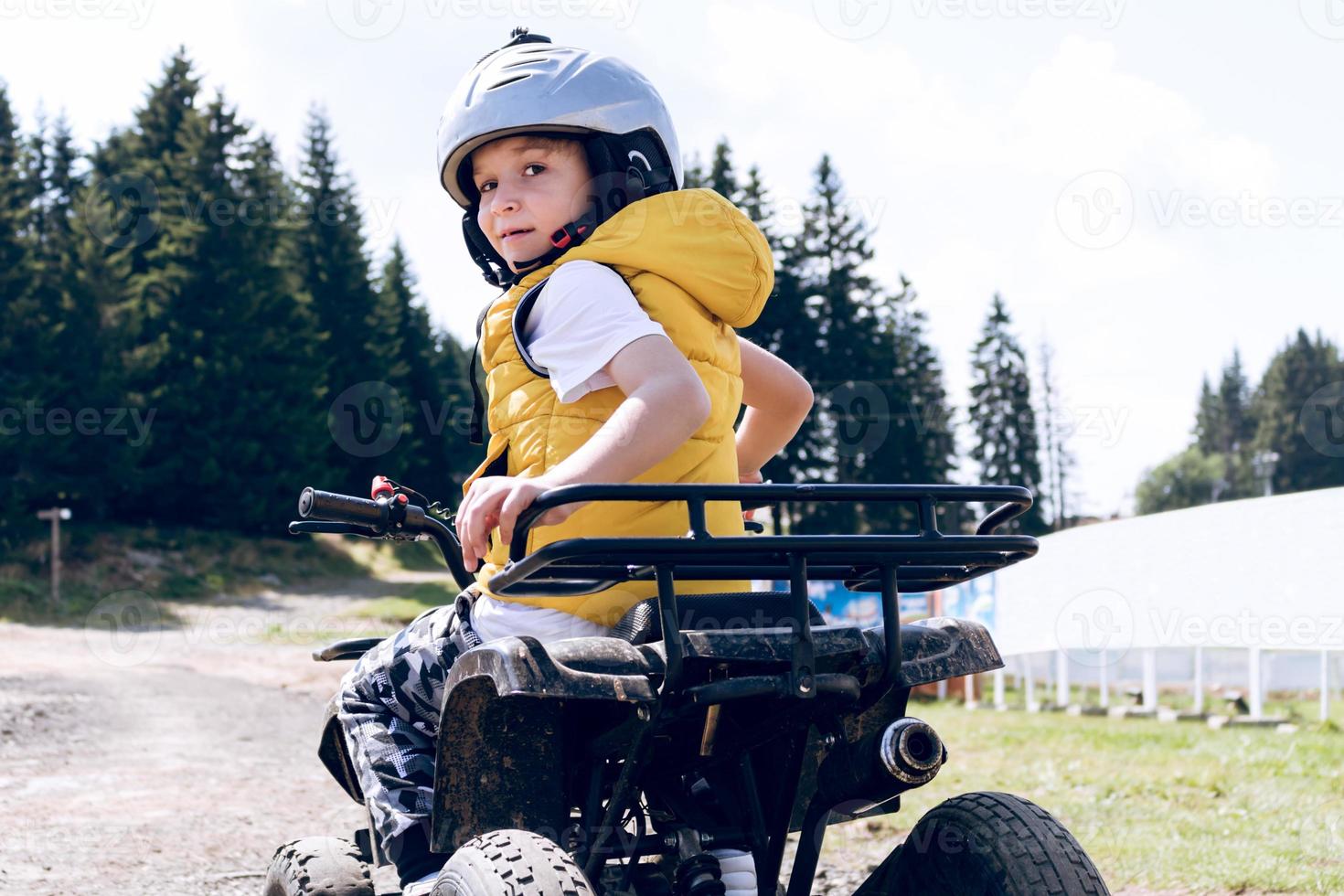 Cute quadbike driver on an adventure. photo