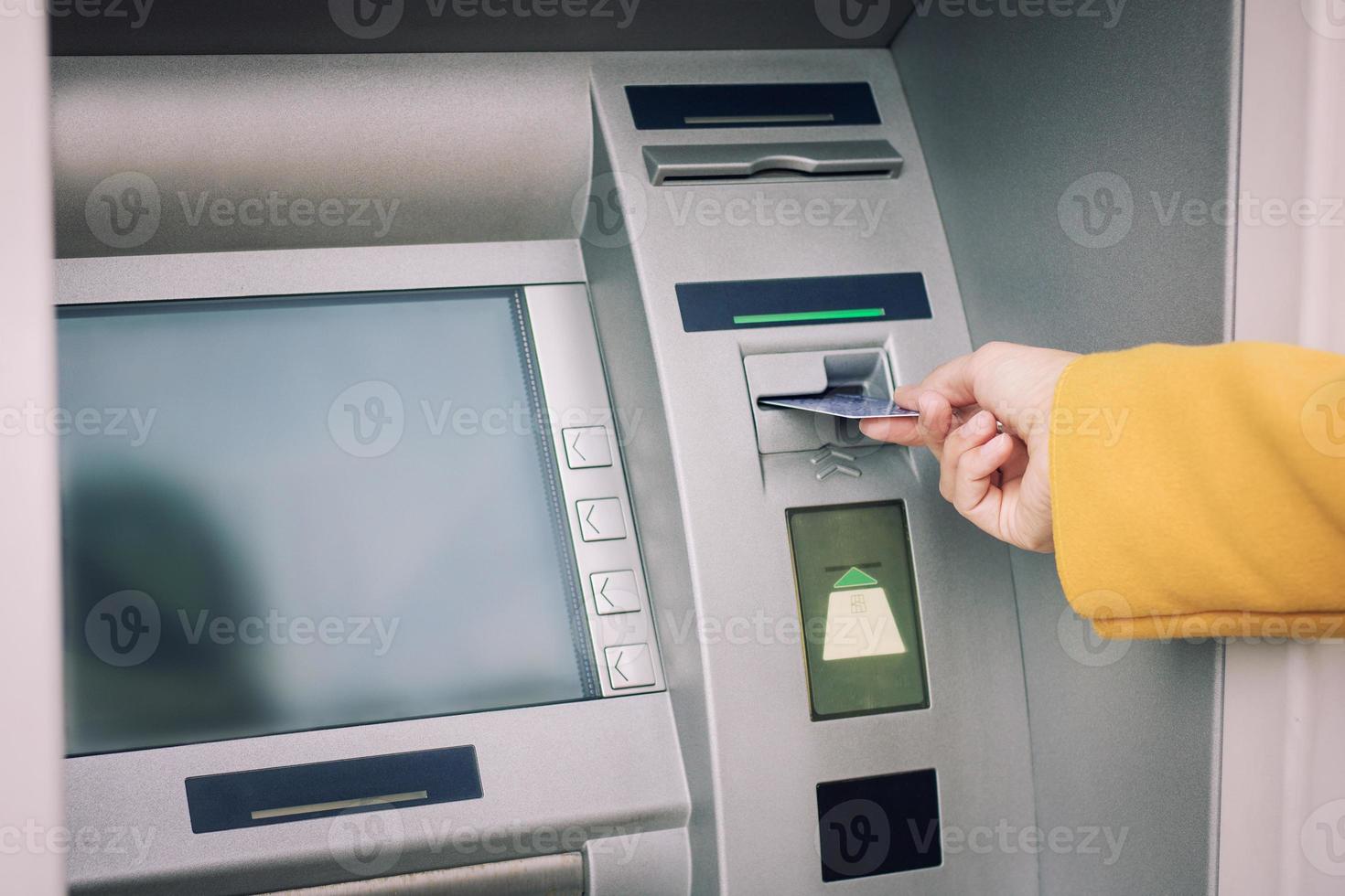 Close up of withdrawing money from ATM. photo