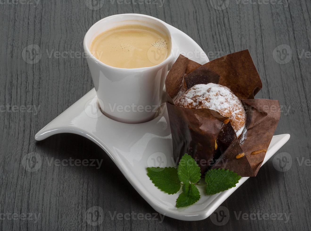 Coffee with muffin on wooden background photo