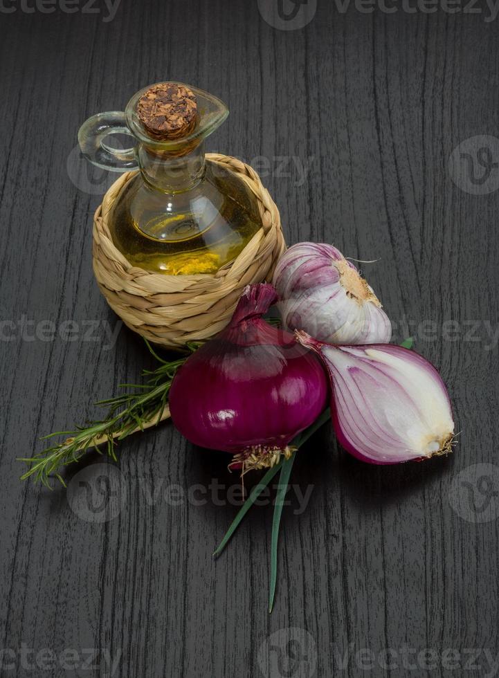 Oil, vinegar with rosemary on wooden background photo