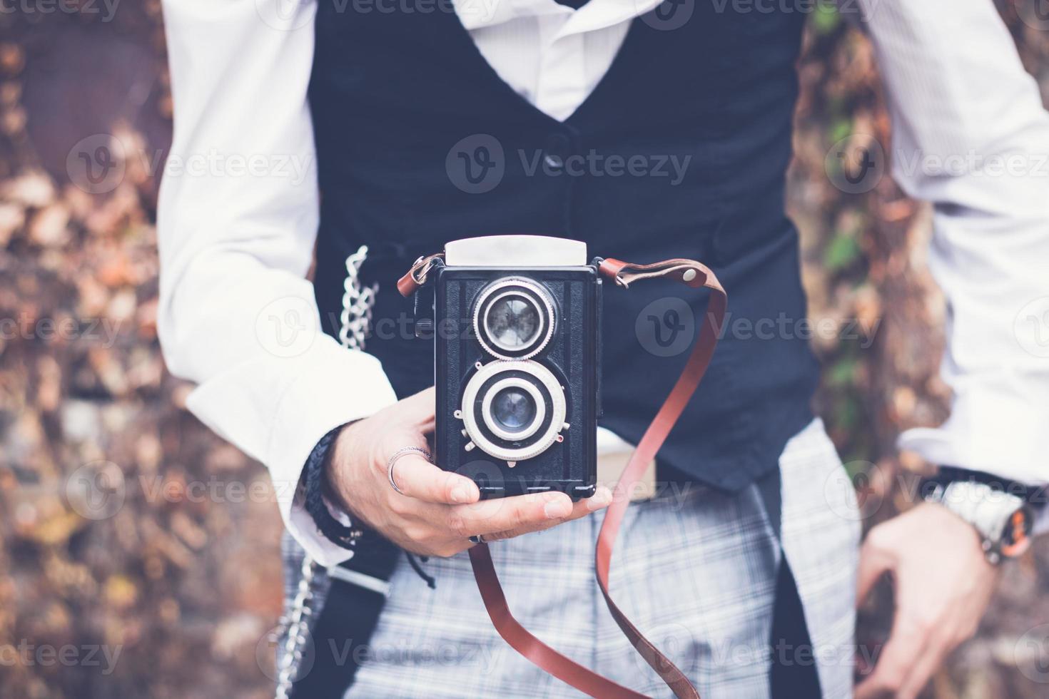 Close up of man with with vintage medium format photo camera.