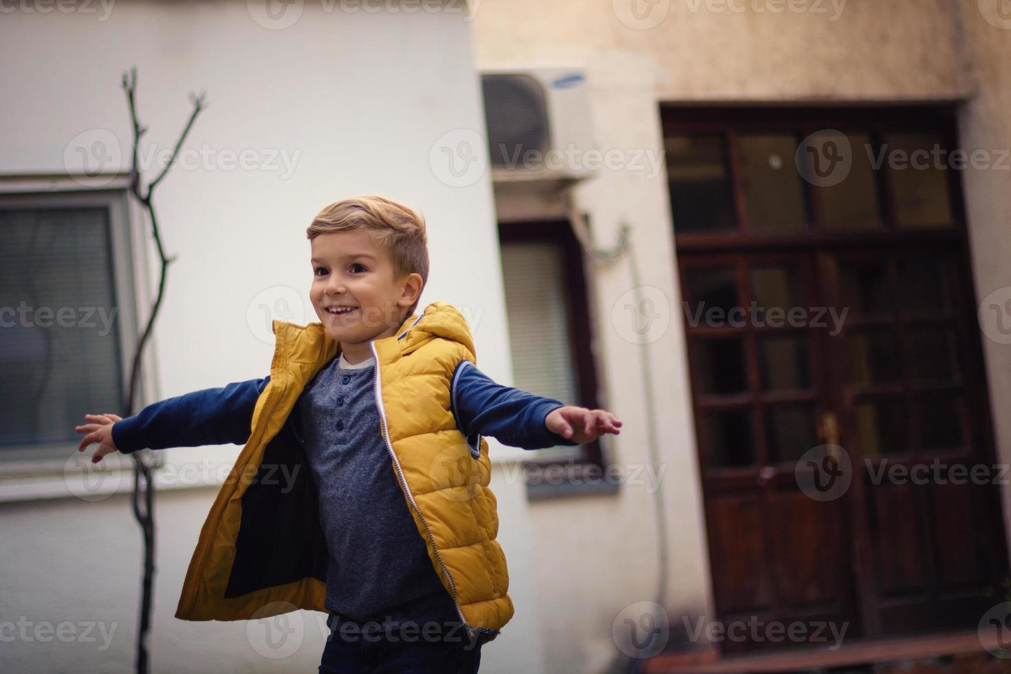 Happy kid turning around and having fun outdoors. photo