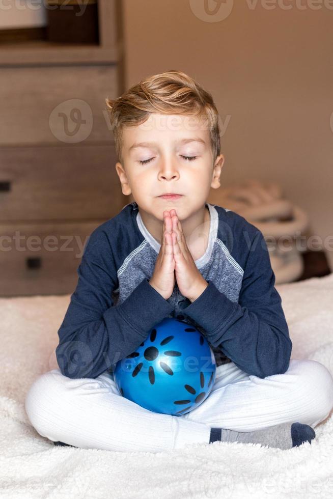 Child praying before bedtime. photo