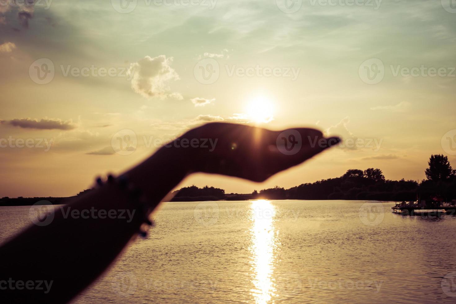 Sunset in a hand. photo