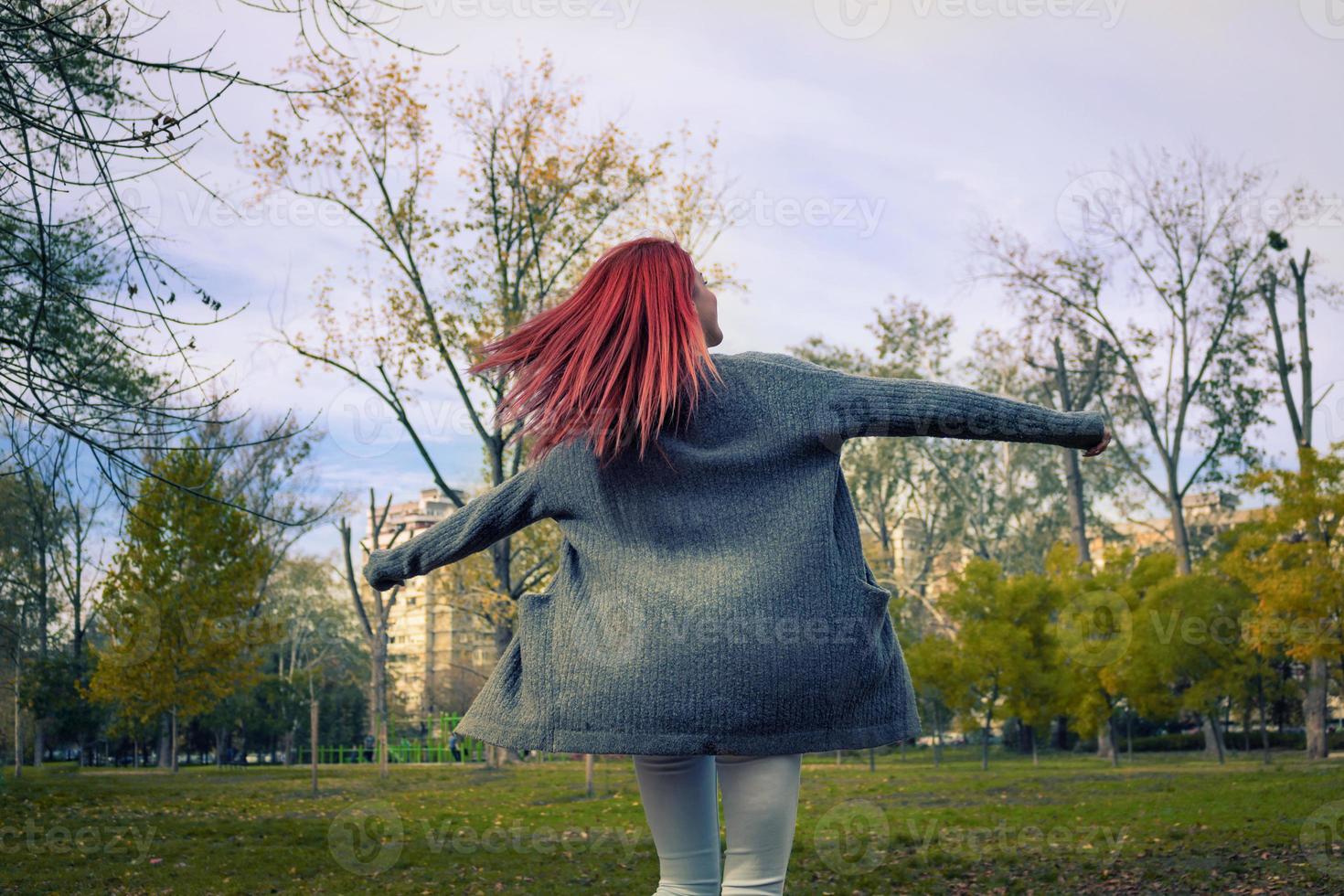 Carefree woman spinning around with arms outstretched. 10910323 Stock