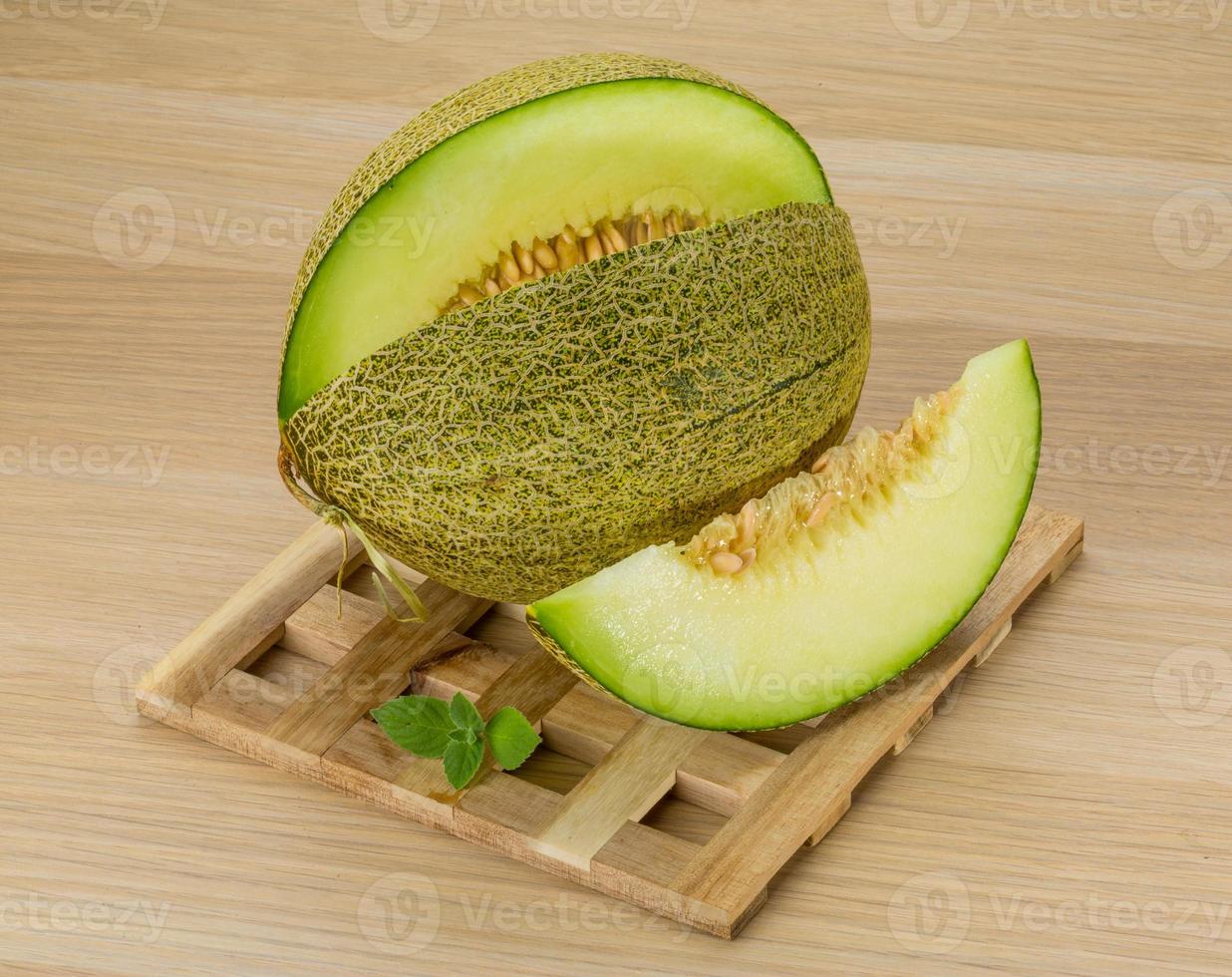 Melon on wooden background photo