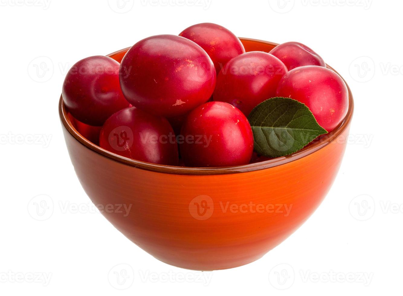 Damson plum in a bowl on white background photo