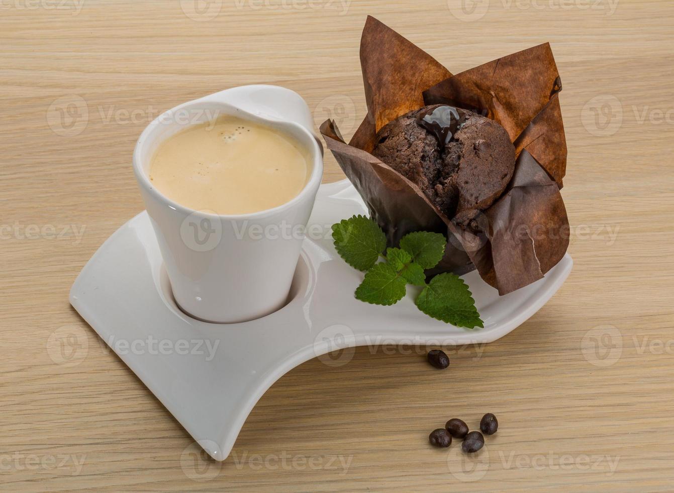 Coffee with muffin on wooden background photo