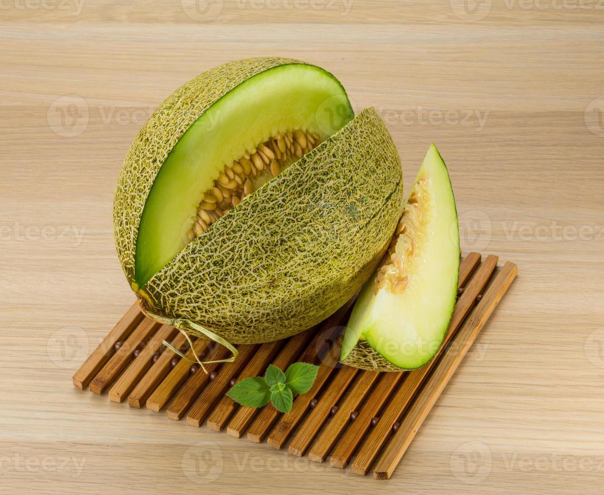 Melon on wooden background photo