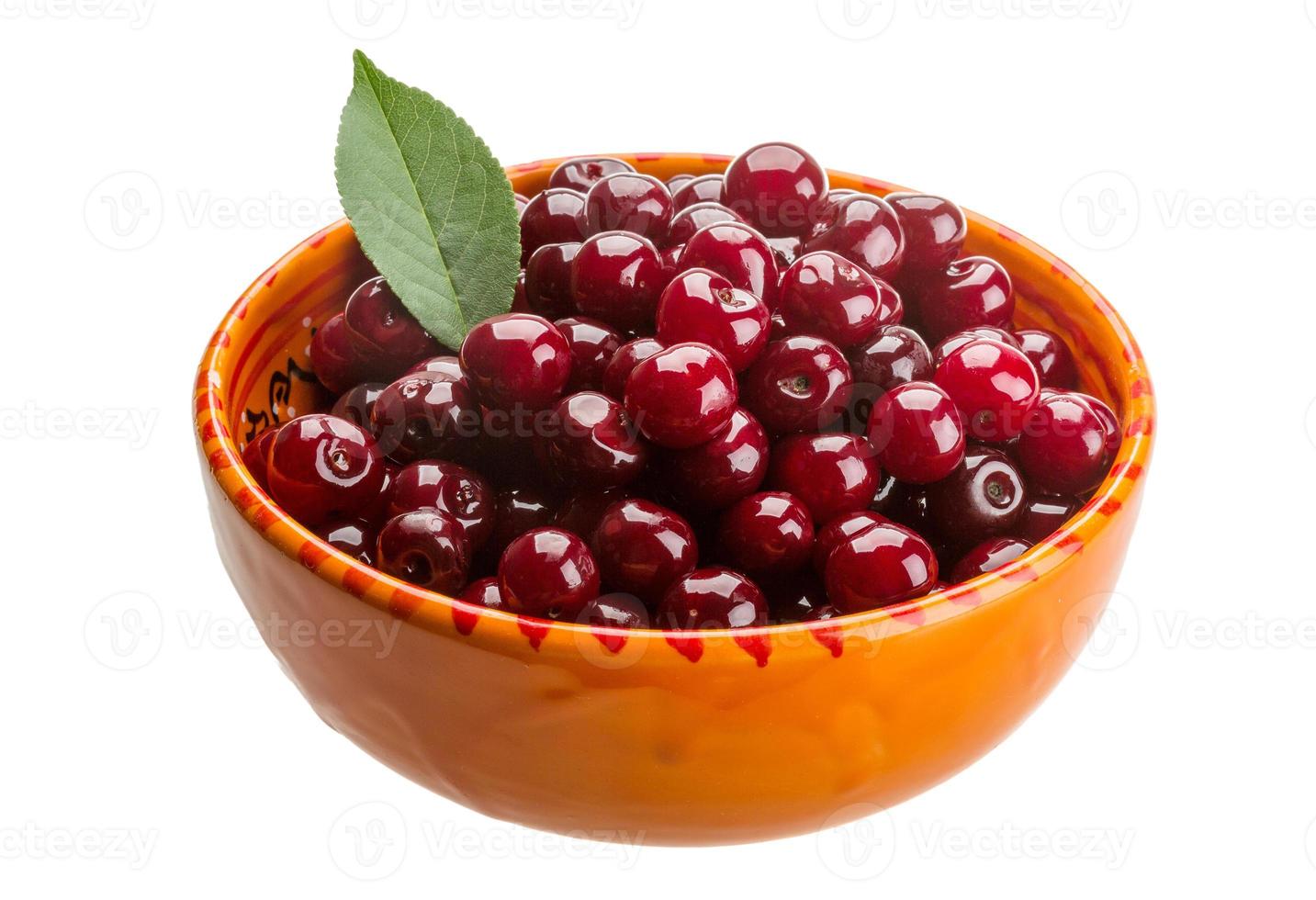 Cherry in the bowl on white background photo