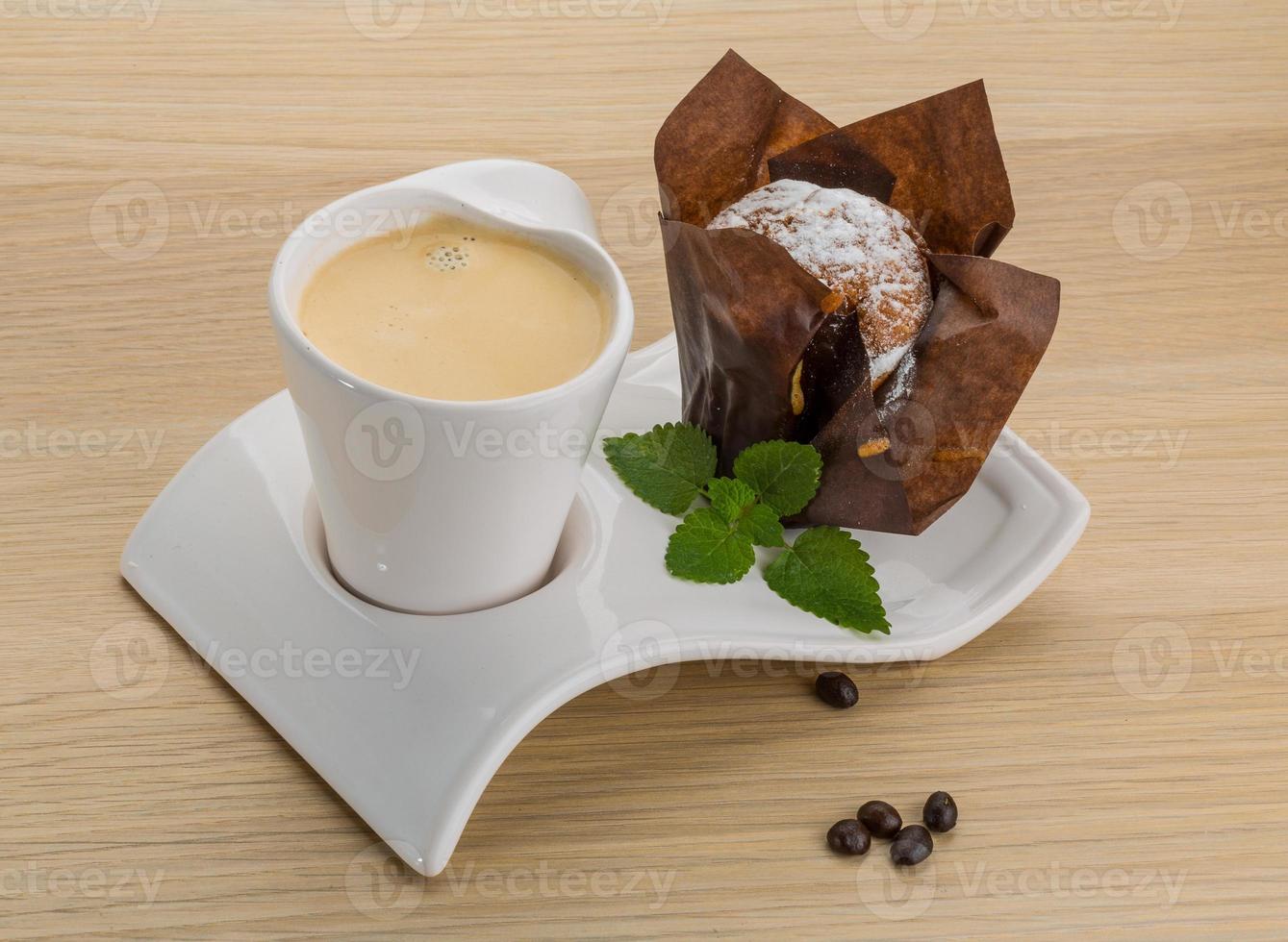Coffee with muffin on wooden background photo