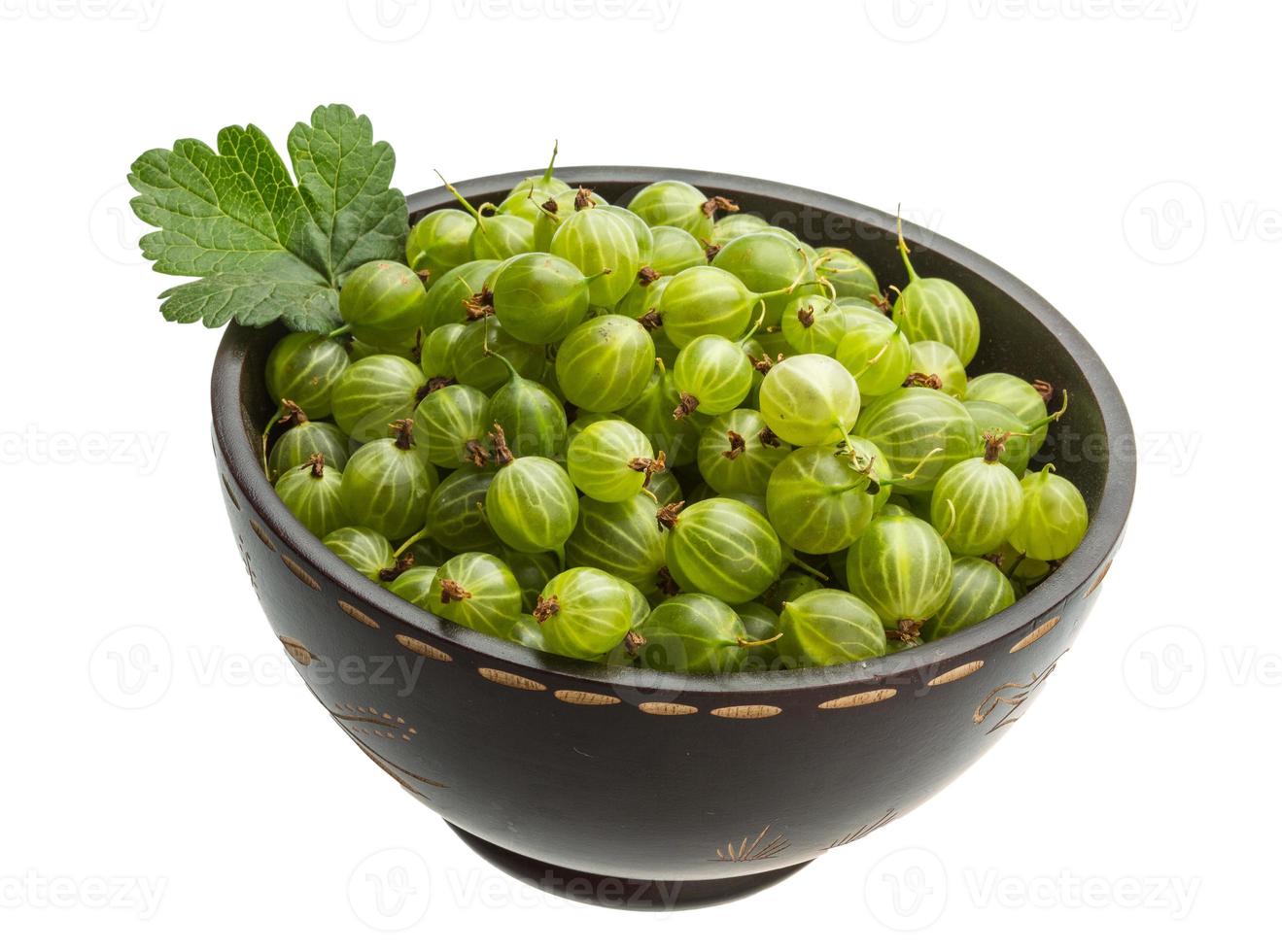 Gooseberries in a bowl on white background photo