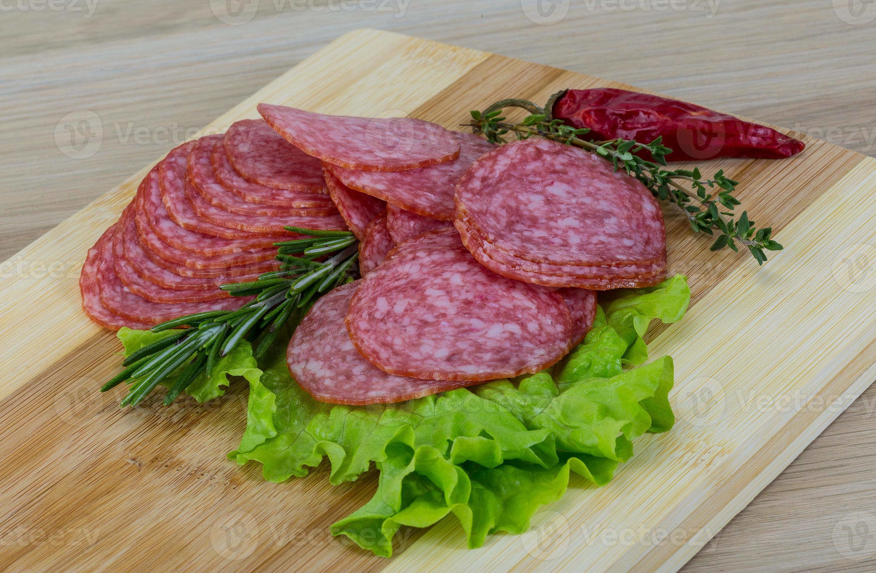 Sliced salami on board 10913591 Stock Photo at Vecteezy