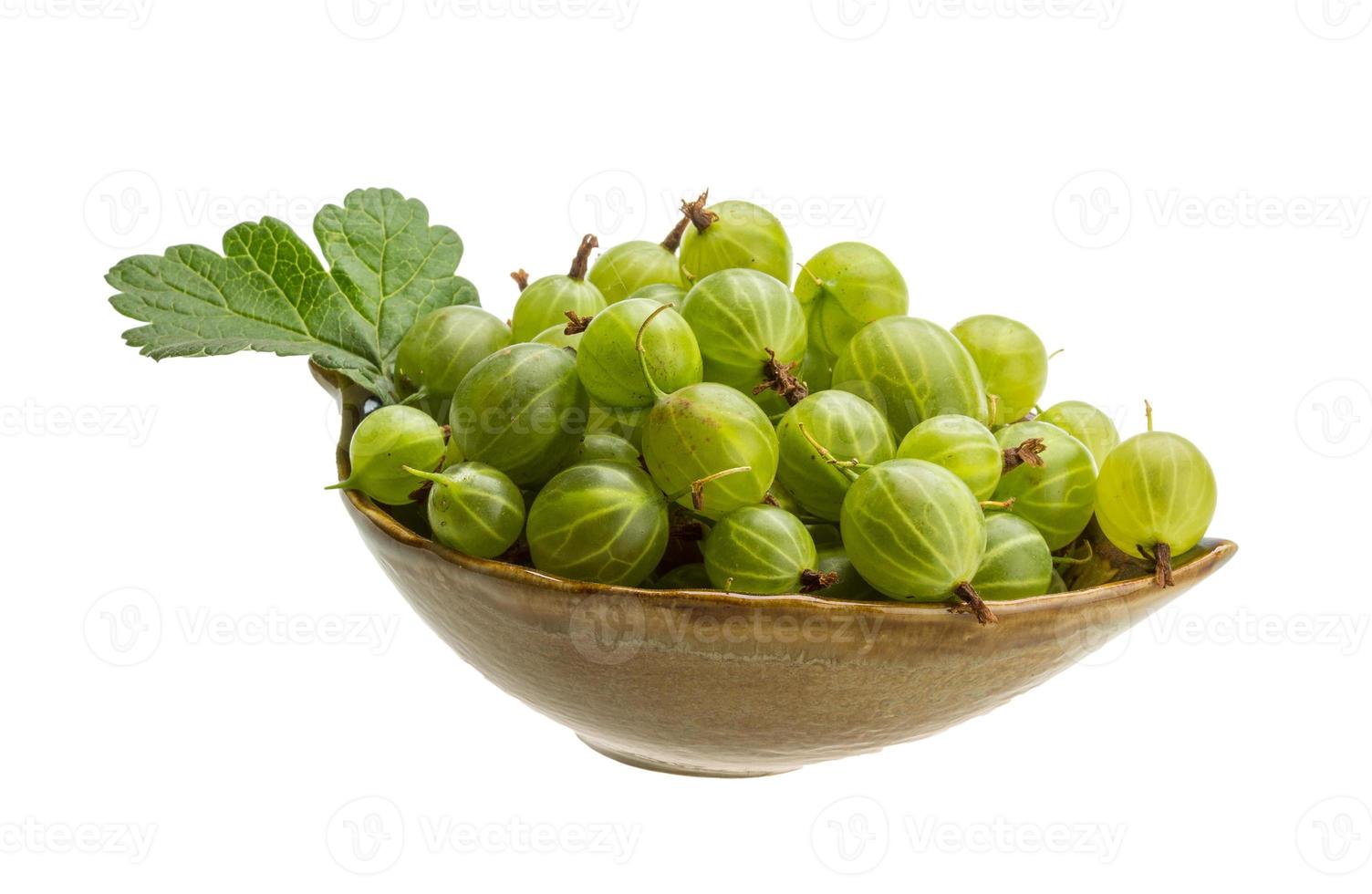 Gooseberries in a bowl on white background photo