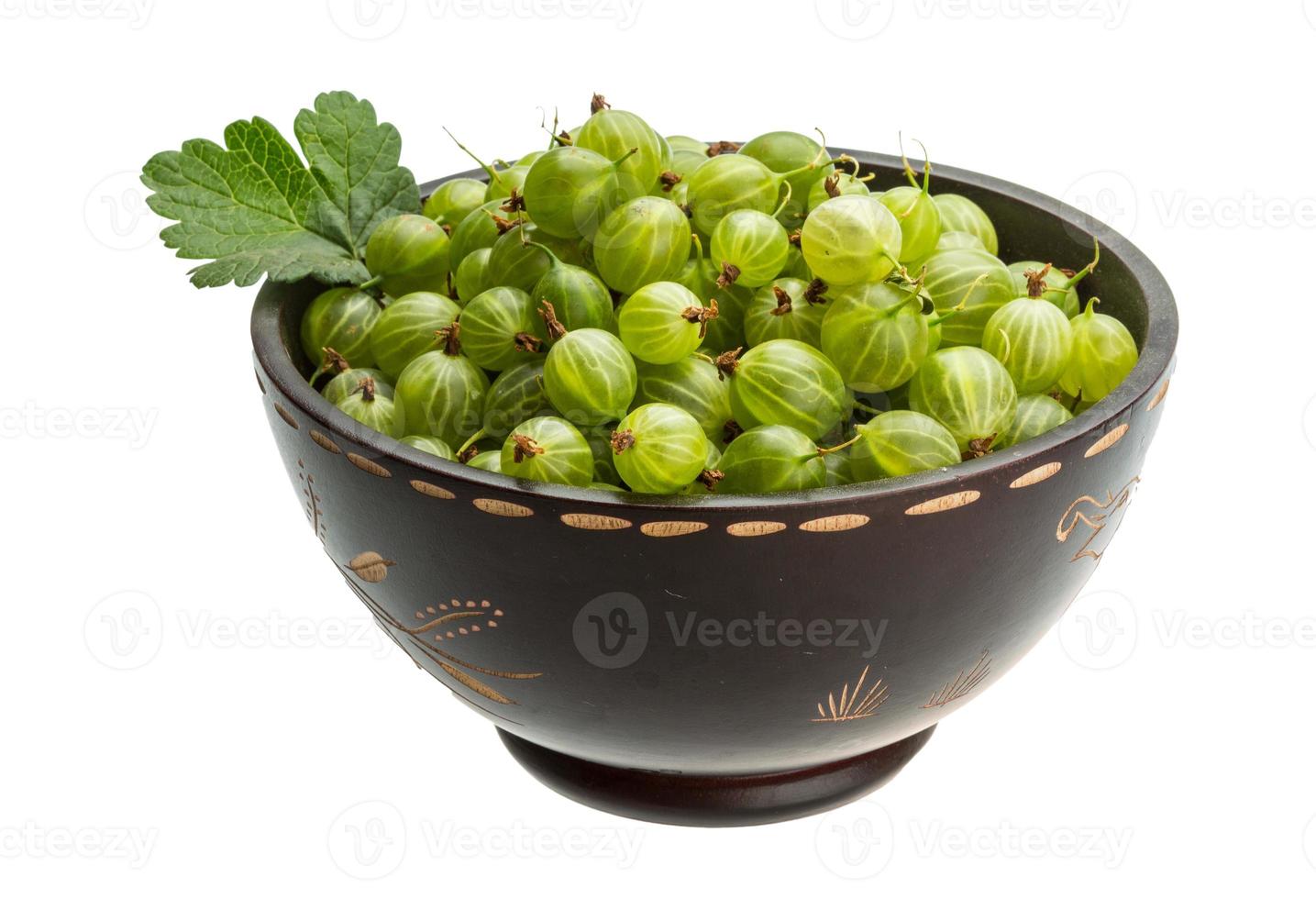 Gooseberries in a bowl on white background photo