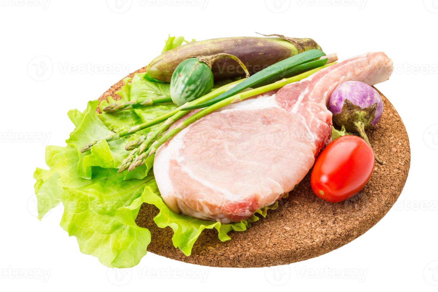 Raw t-bone steak on wooden board and white background photo