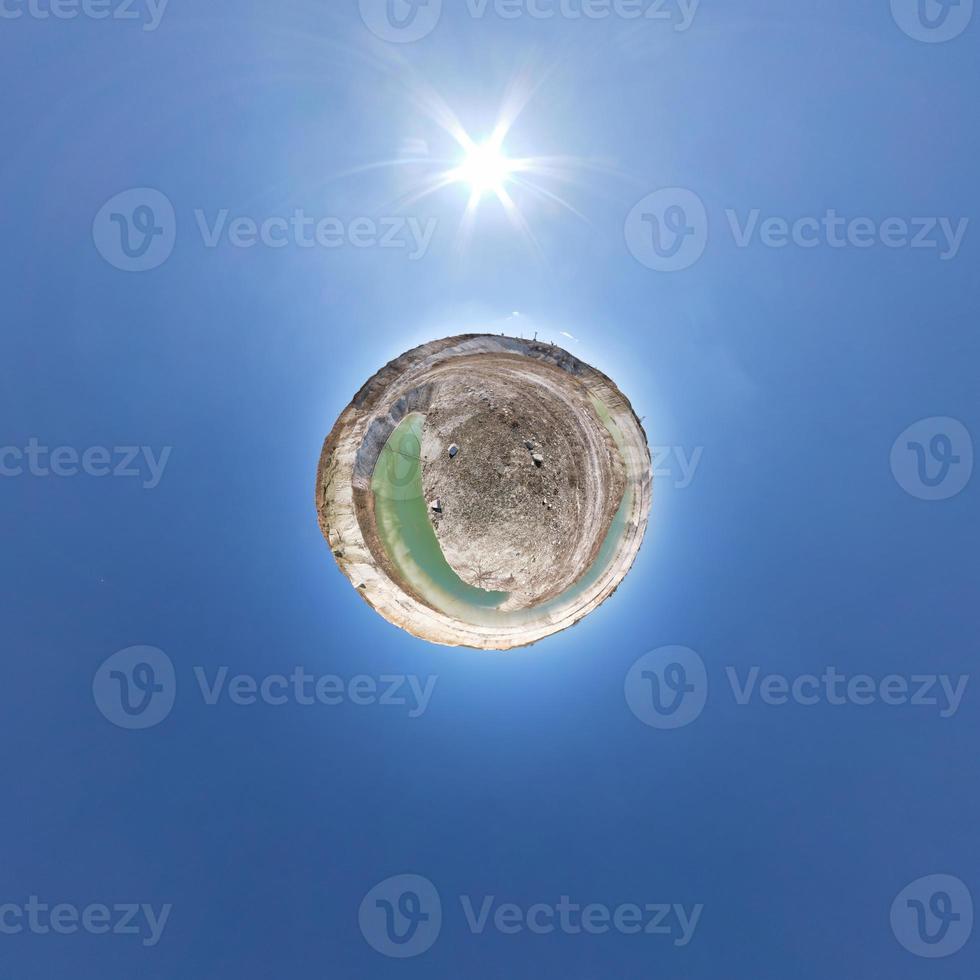 Little planet transformation of spherical panorama 360 degrees. Spherical abstract aerial view in field with clear sky and awesome beautiful clouds. Curvature of space. photo