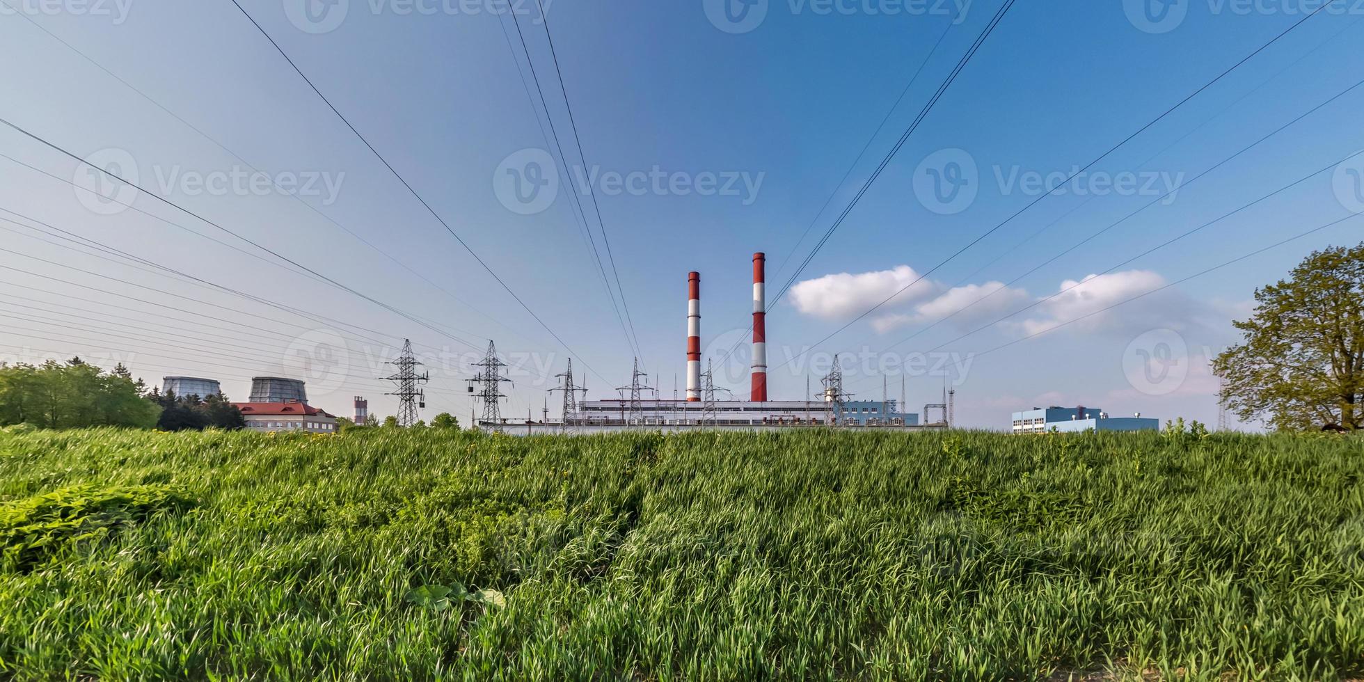 Silhouette of the high voltage electric pylon towers on the background of beautiful evening clouds photo