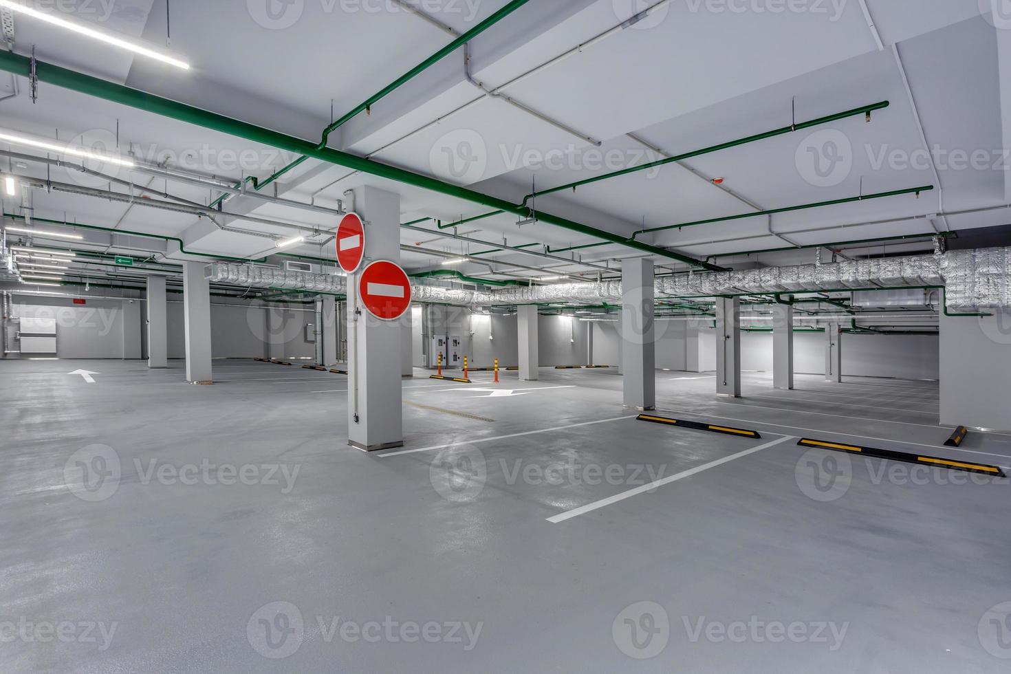 empty underground garage parking with columns and road markings photo