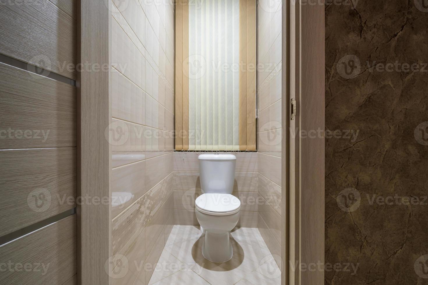 toilet and detail of a corner shower cabin with wall mount shower attachment photo