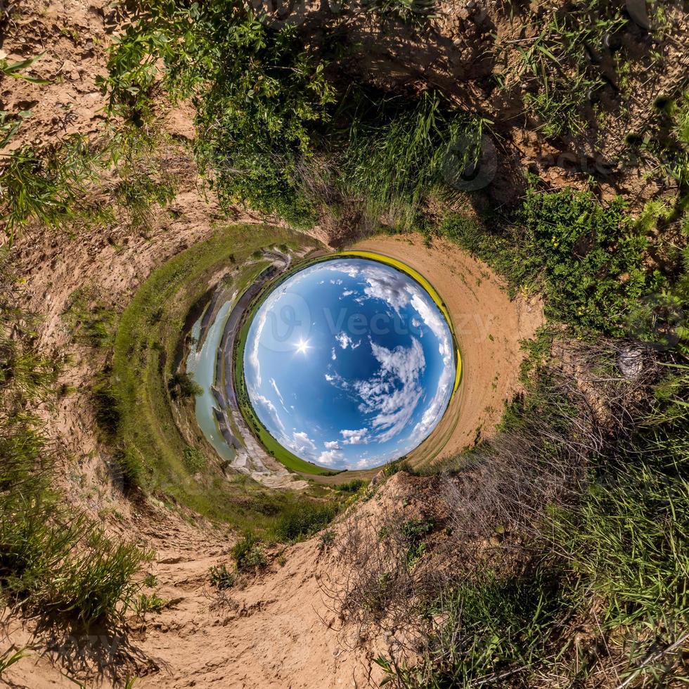 Inversion of little planet transformation of spherical panorama 360 degrees. Spherical abstract aerial view on field with awesome beautiful clouds. Curvature of space. photo
