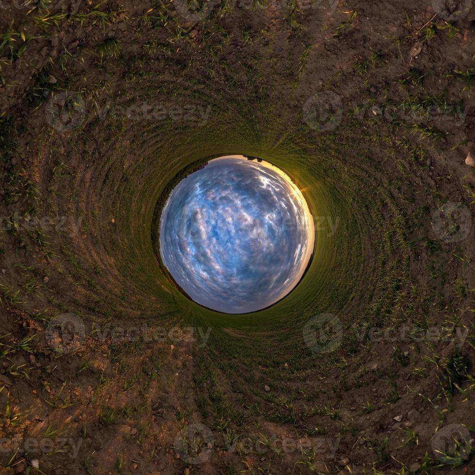 blue sky ball among green grass. Inversion of tiny planet transformation of spherical panorama 360 degrees. Spherical abstract view. Curvature of space. photo