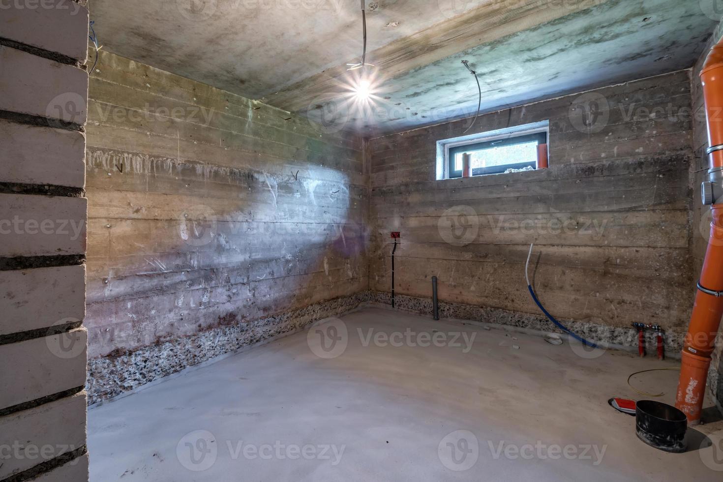 Empty basement room with minimal preparatory repairs in interior with white brick walls photo