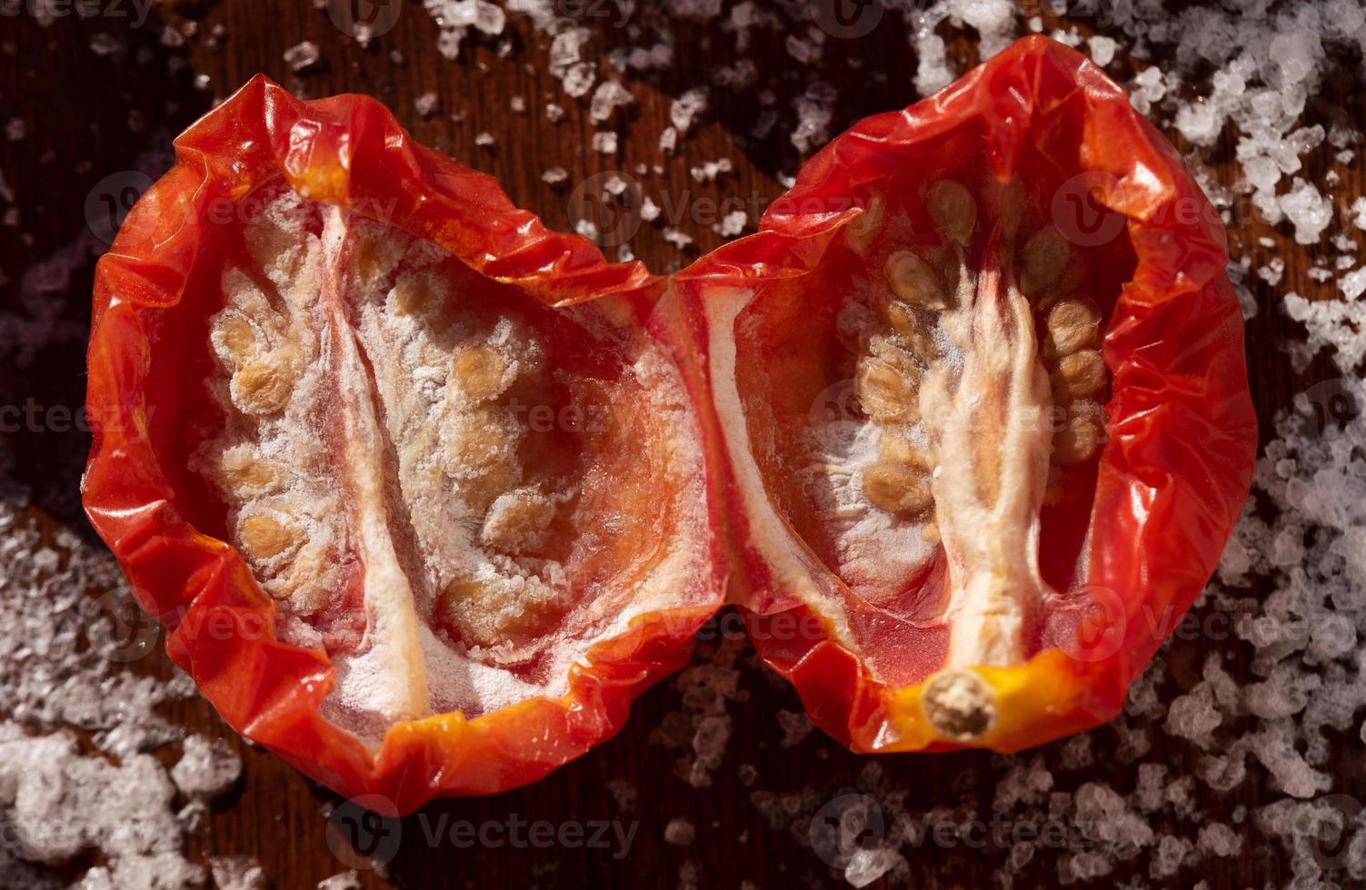 Close-up of tomatoes laid out side by side for drying and canning. The tomatoes are salted. photo