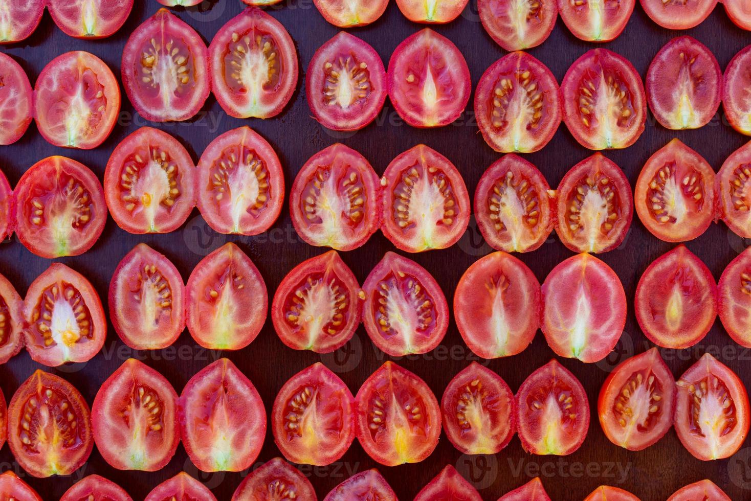 Sliced red fresh tomatoes makes a background photo