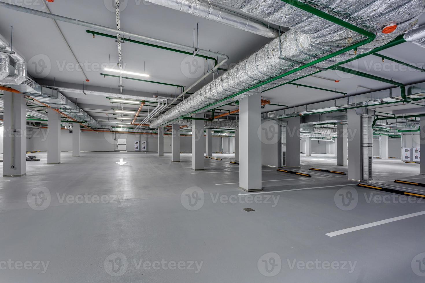 empty underground garage parking with columns and road markings photo