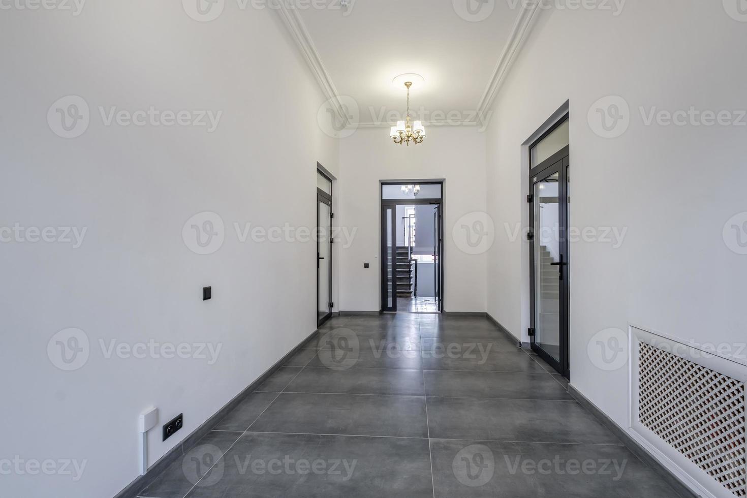 long white empty corridor in interior of entrance hall of modern apartments, office or clinic photo